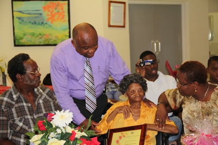 Minister responsible for the wellbeing of senior citizens on Nevis Hon. Hensley Daniel greets birthday girl Mrs. Lucina Brown and her family (extreme right Carol Hendrickson)